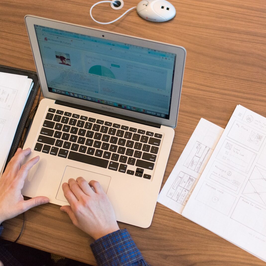 Person's Hands on Top of Macbook Air